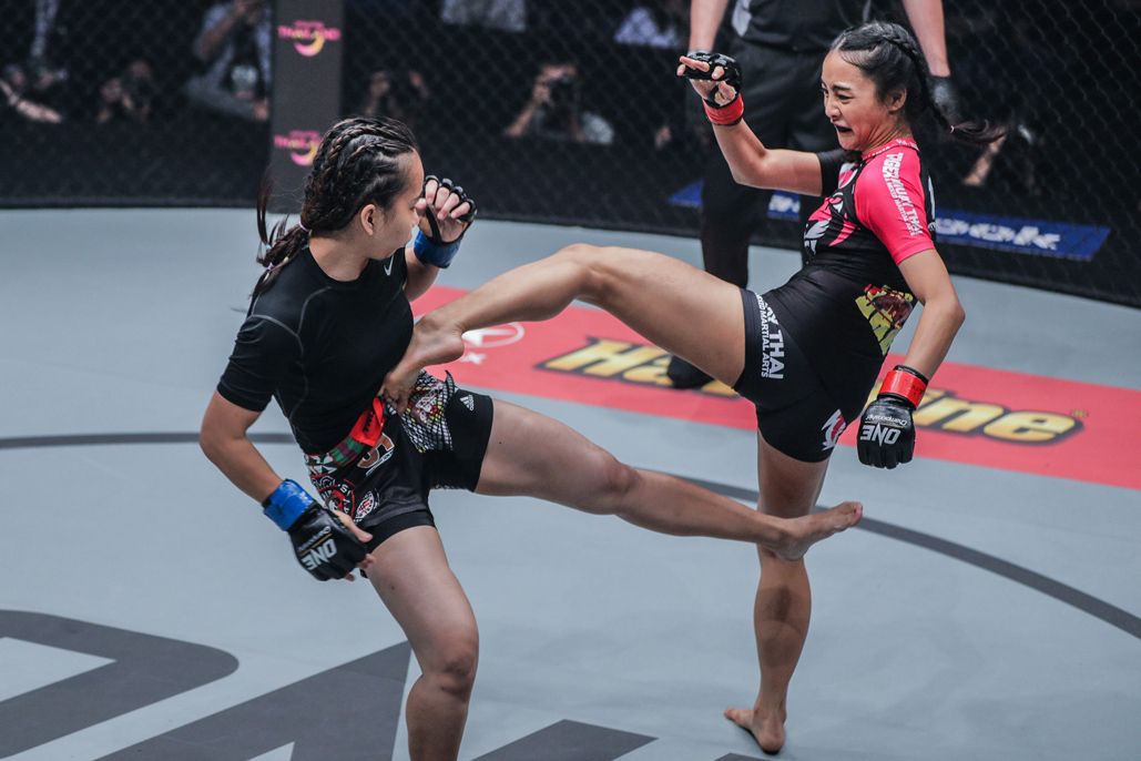 Thai mixed martial artist Rika Ishige connects with a body kick on Nita Dea