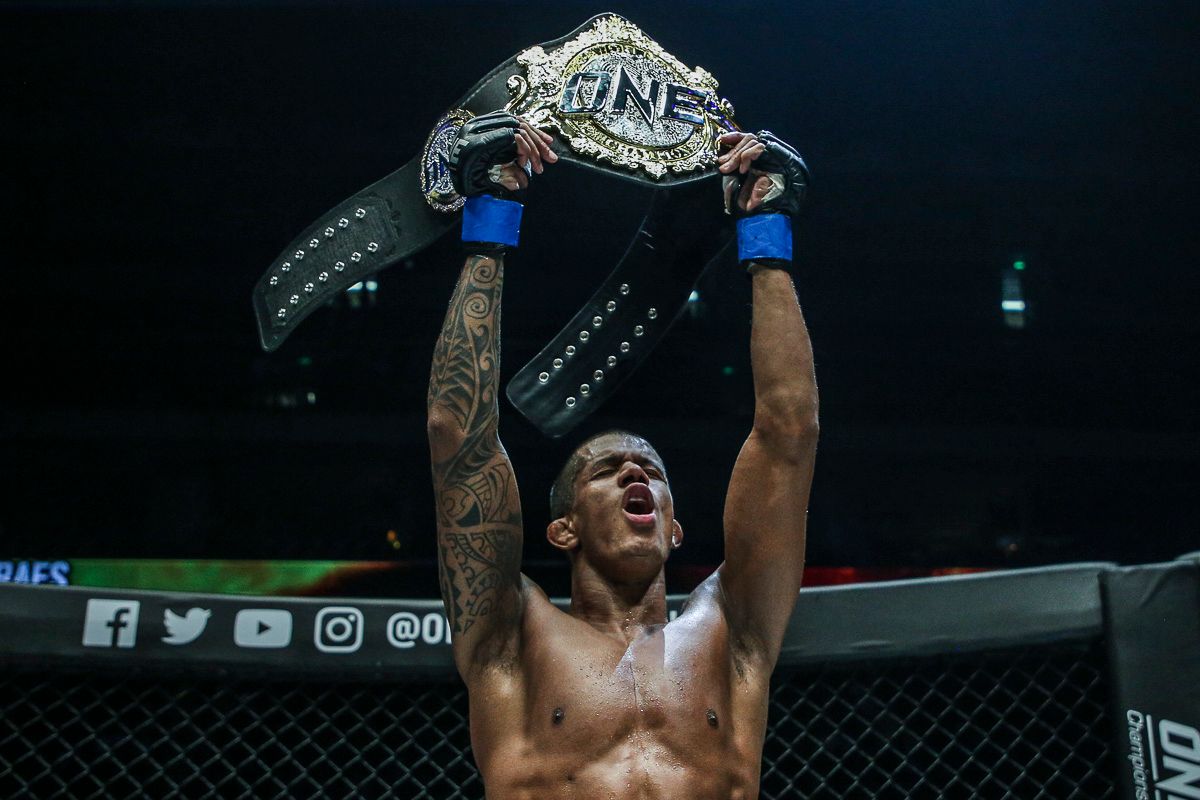 ONE Flyweight World Champion Adriano Moraes raises his belt