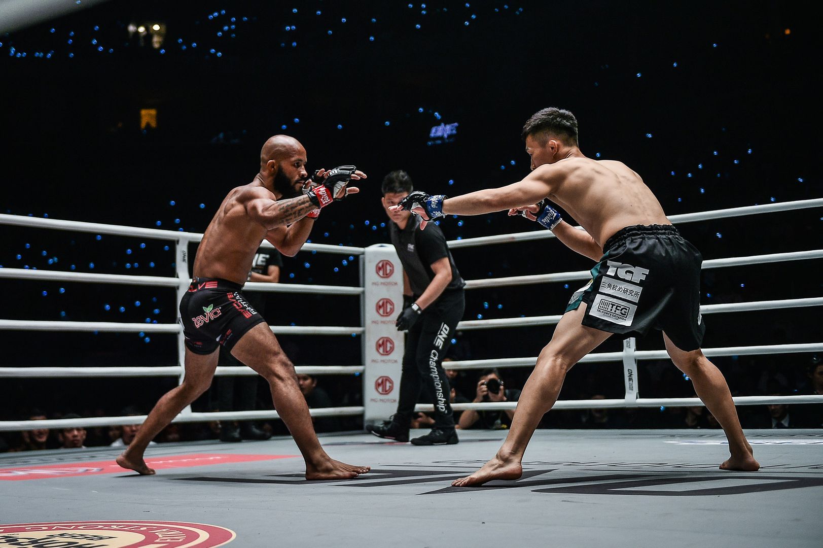 Tatsumitsu Wada and Demetrious Johnson size each other up in the ring