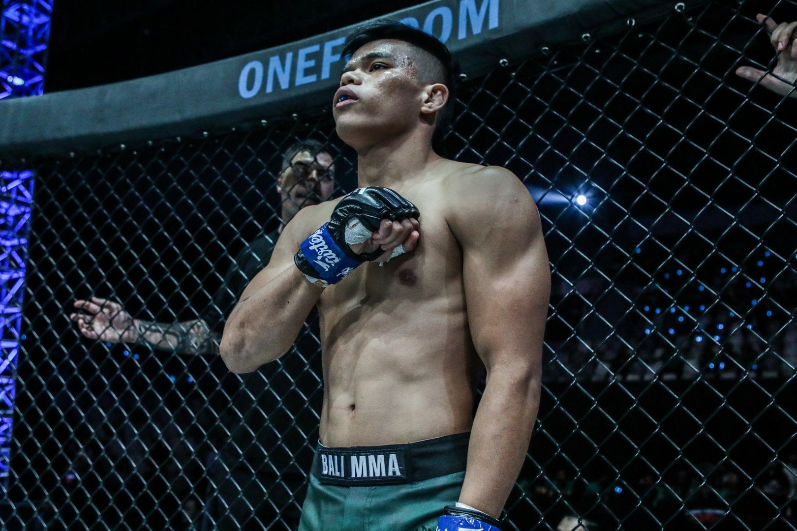 Indonesian MMA fighter Elipitua Siregar stands inside the cage, ready for battle