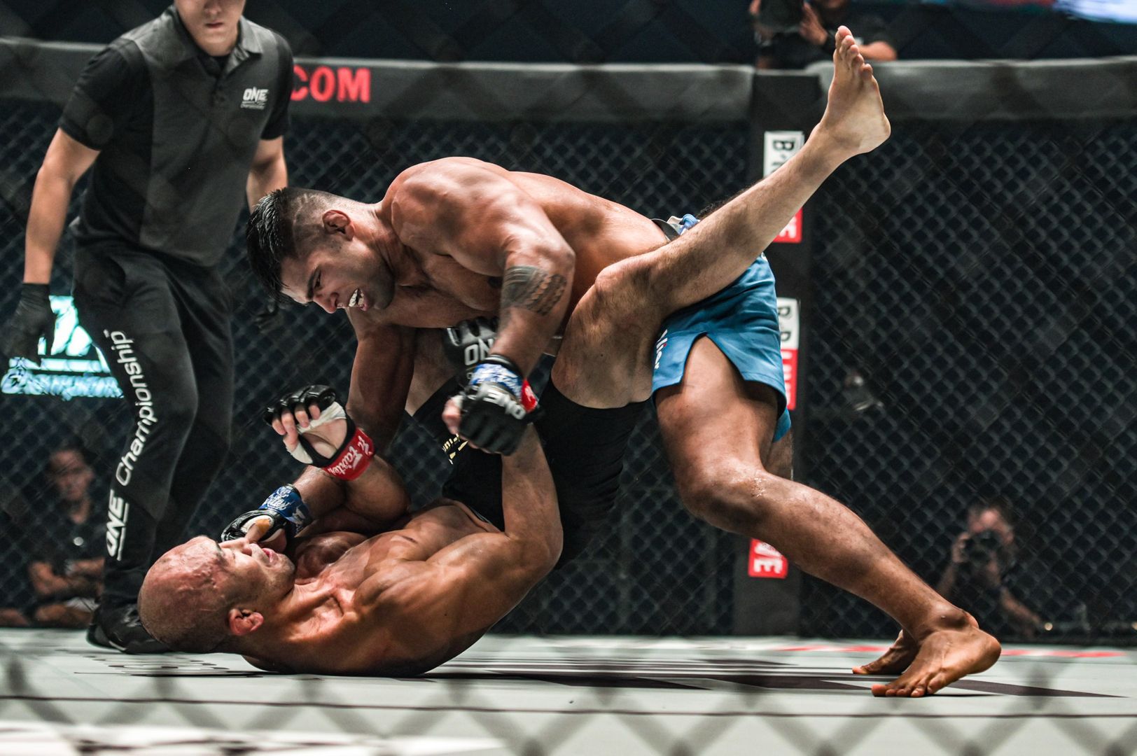 Malaysian sensation Agilan Thani punches Japanese legend Yushin Okami from inside the guard