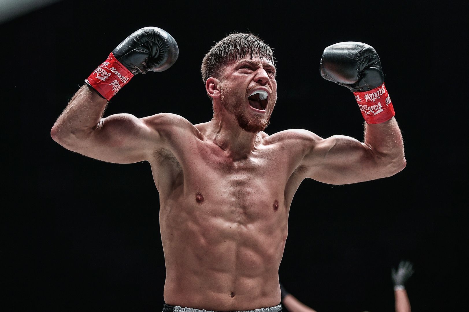 German kickboxer Enriko Kehl flexes hard following his win over Armen Petrosyan