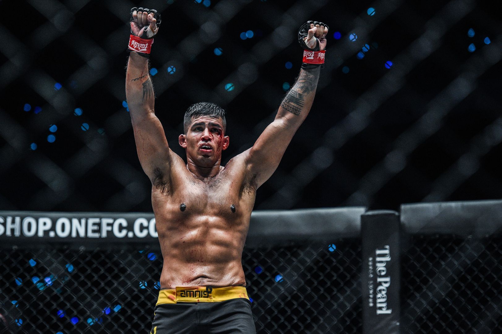 Malaysian sensation Agilan Thani raises his hands following his victory in December 2019