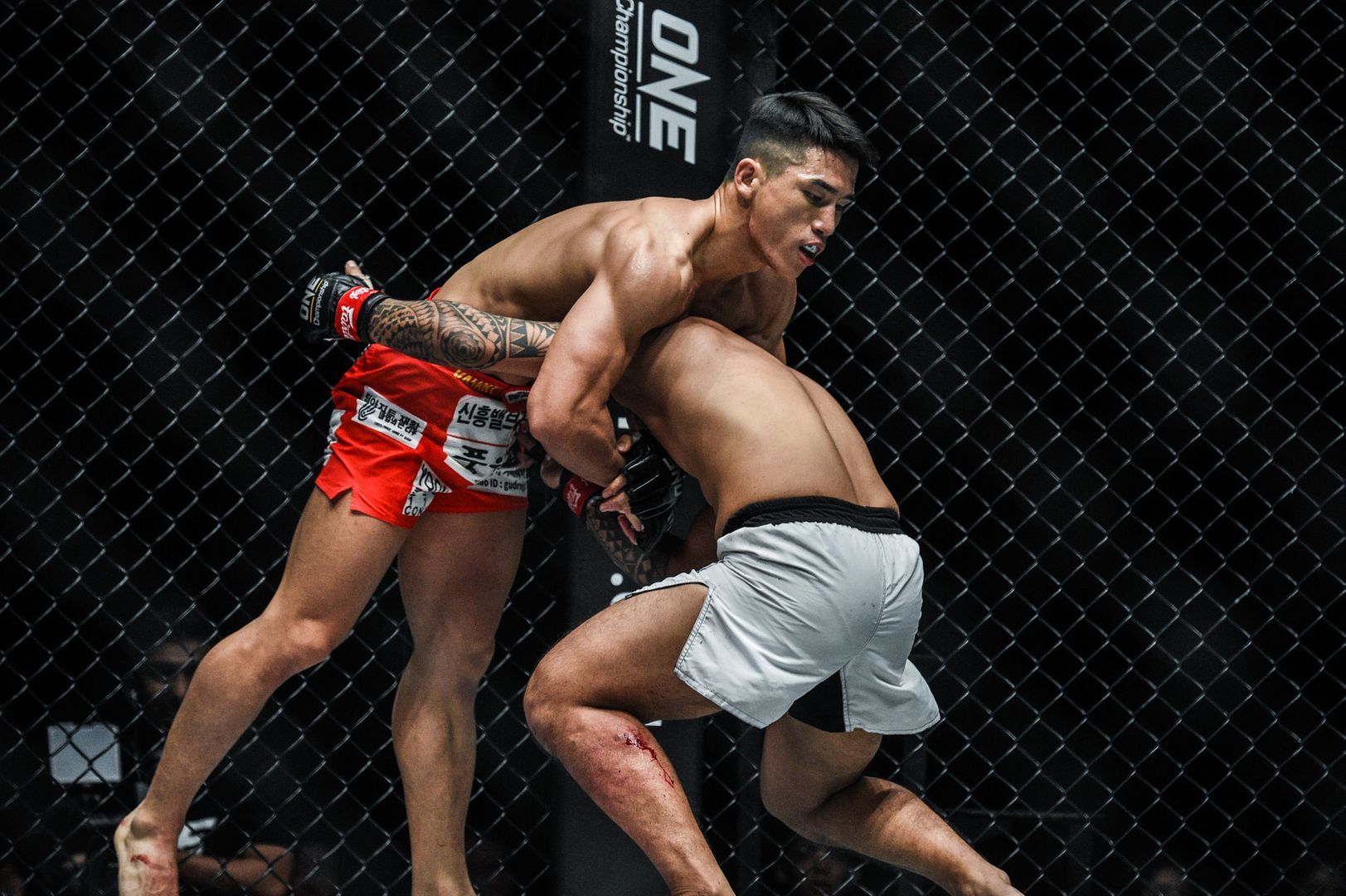 South Korean Yoon Chang Min grabs a headlock