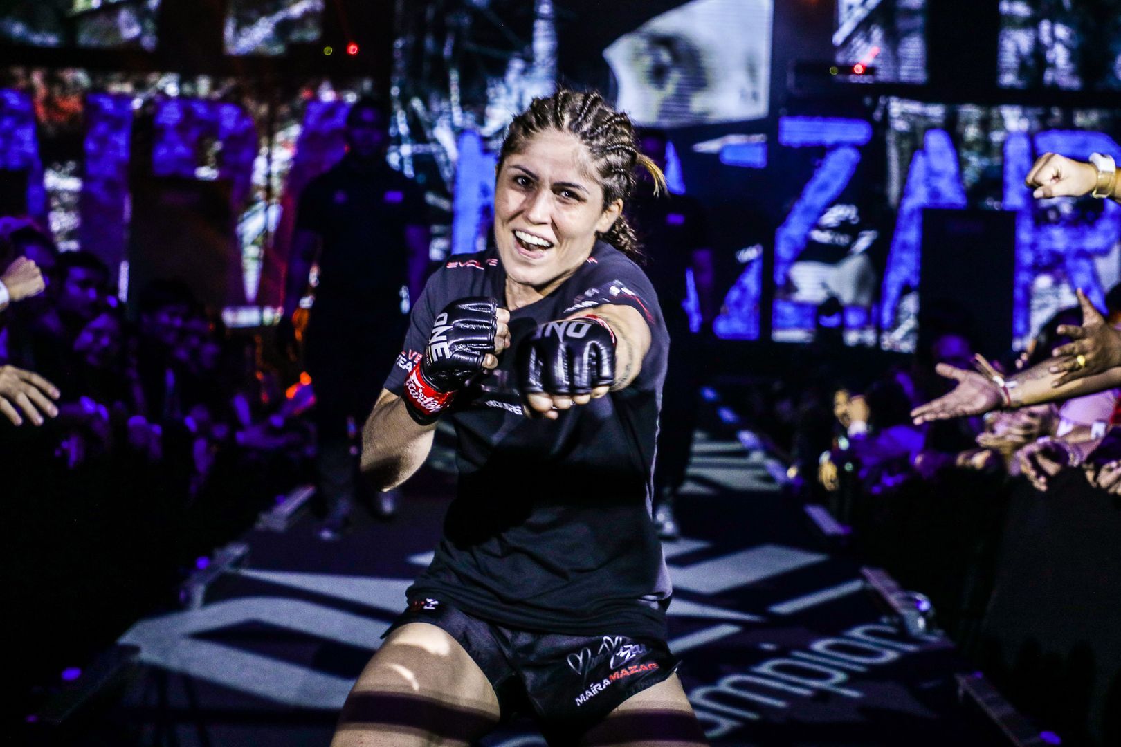Brazilian MMA fighter Maira Mazar throws a punch on her way to the cage