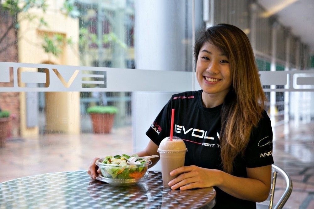 ONE Women's Atomweight World Champion Angela Lee eats a salad and drinks a smoothie at Evolve MMA