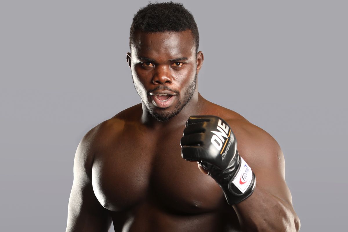 African MMA fighter "Reug Reug" holds up ONE fist