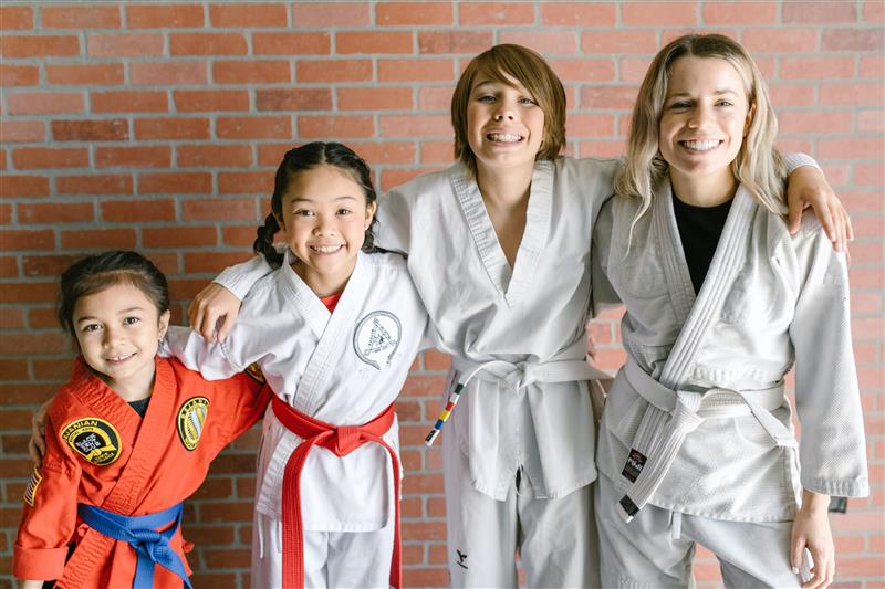 A group of kids get ready for martial arts class