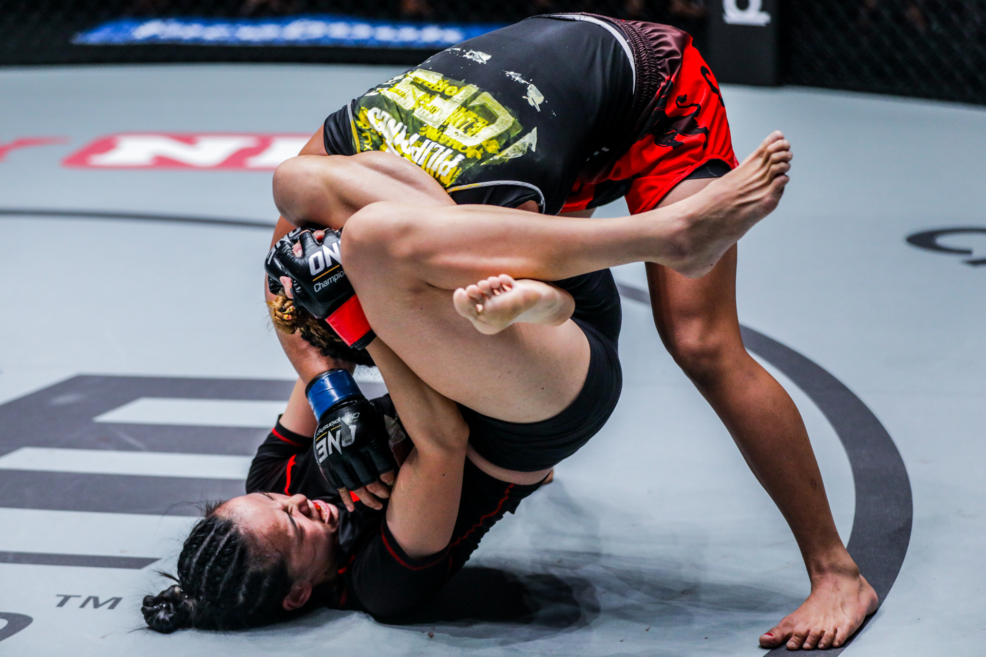 Lin Heqin locks in a triangle choke.jpg