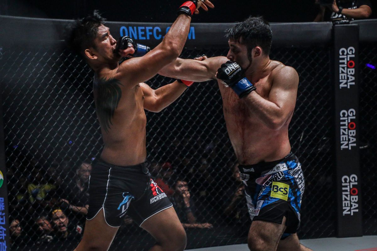 Japanese MMA fighter Ken Hasegawa punches Aung La N Sang in their iconic first showdown