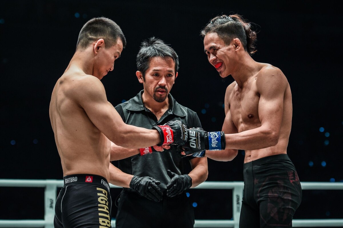 Jeremy Miado and Miao Li Tao touch gloves