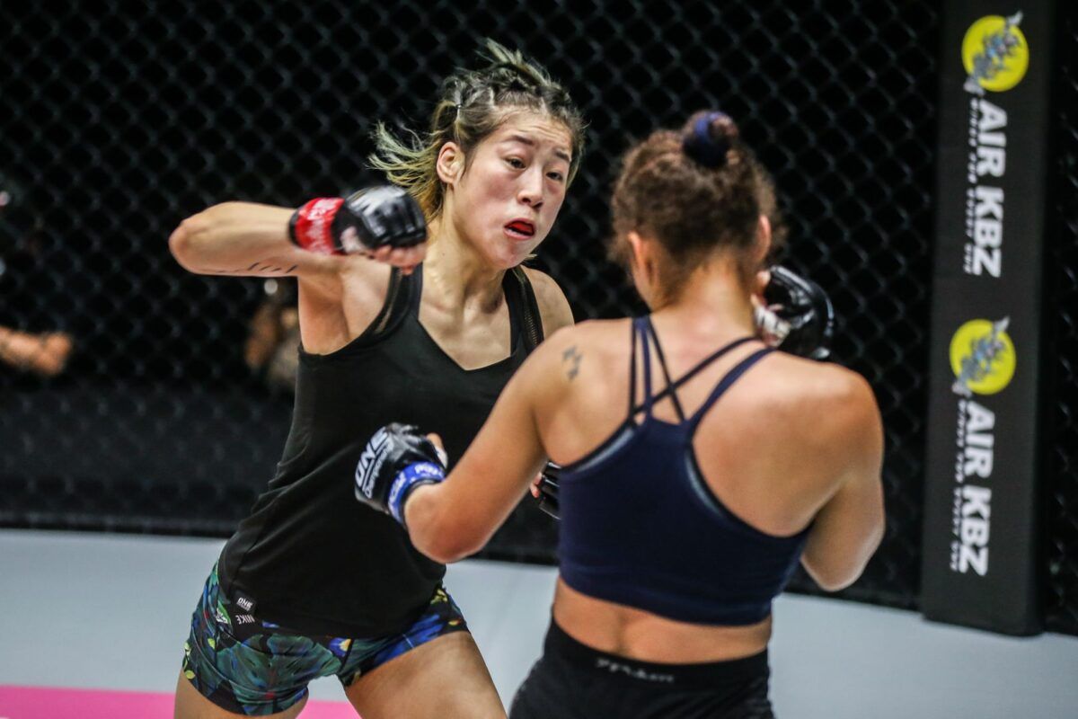 Chinese MMA fighter Meng Bo throws a cross a Samara Santos