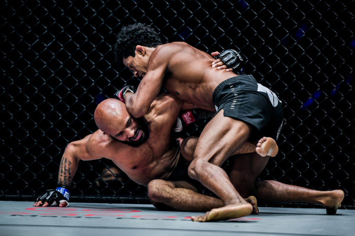 Brazilian MMA fighter Adriano Moraes drills Demetrious Johnson with a knee