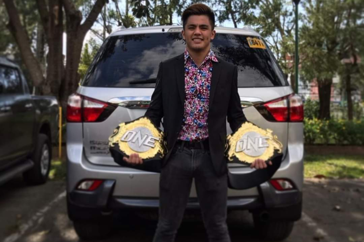 Jhanlo Sangiao poses with ONE Championship belts