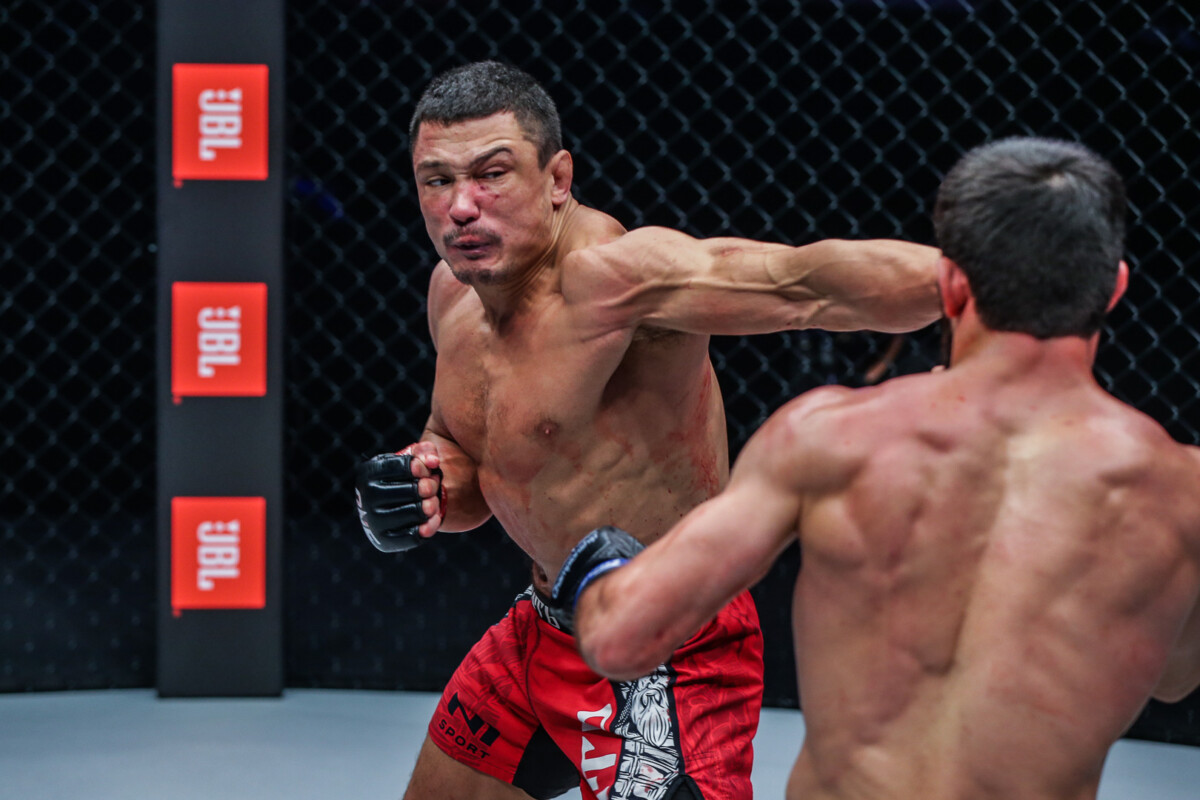 Timofey Nastyukhin throws a left hook toward Dagi Arslanaliev at ONE: WINTER WARRIORS.